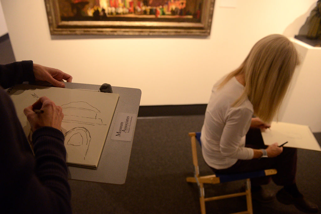 From left, sketching group co-ordinator Stacey Thompson sketches from Dean Cornwell's The Church of the Holy Sepulchre as group member Donna Haun